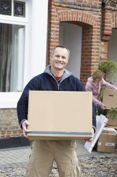 Removal team planning a London house move with boxes and furniture