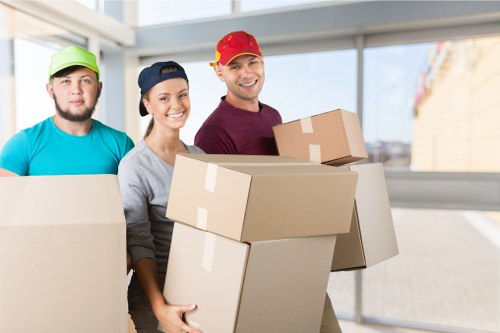Removal team preparing a London home move with furniture and boxes