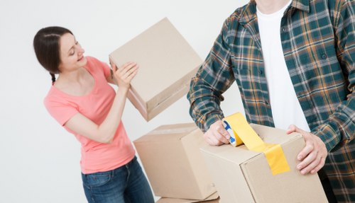 Professional local movers transporting bulky furniture across London