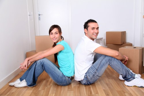 Moving crew carrying furniture through a London property staircase
