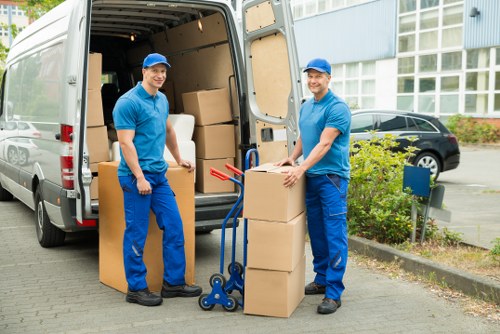 Packing boxes and furniture arranged for a London house move