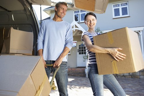 Careful loading of unwanted furniture into a collection vehicle in London